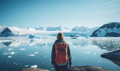 Fotobehang Antarctic Polar Expedition: A Happy Tourist Woman with a Backpack Explores Antarctica's Adventurous Terrain, Surrounded by Towering Icebergs and Pristine Snowfields  © Mr. Bolota