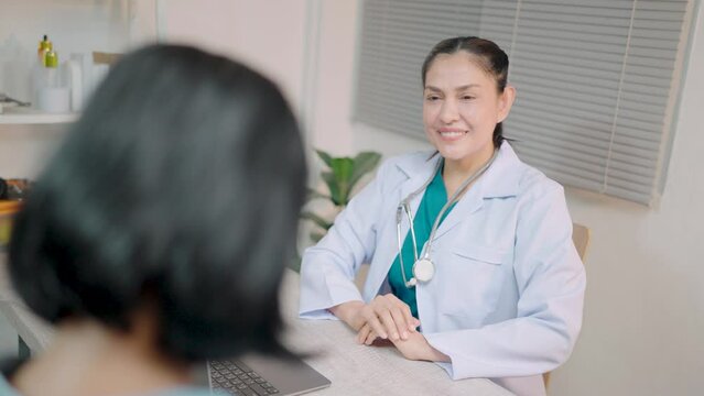 Female doctor in white robe and stethoscope on neck talking with elderly patient Consult about health, write a complaint Fill out medical forms health examination, health care,