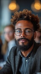 Fototapeta premium A man with glasses and curly hair, sporting a beard, looks pensive in a softly lit room, generative ai