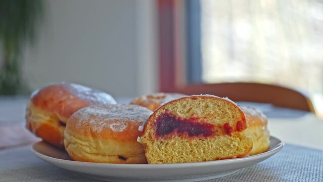 Sweet Delicious Traditional Polish Glazed Doughnut Paczek Filled with Sweet Jam Marmalade Prepared for Dessert on Fat Thursday Celebration before Ash Wednesday and Lent