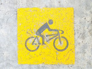 Faded bicycle lane symbol. Black bicycle street marking for bicycle lane