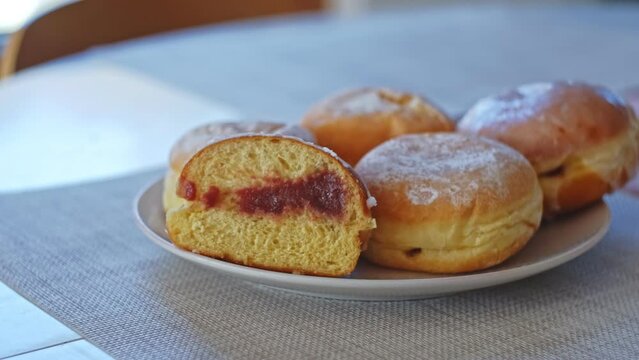 Sweet Delicious Traditional Polish Glazed Doughnut Paczek Filled with Sweet Jam Marmalade Prepared for Dessert on Fat Thursday Celebration before Ash Wednesday and Lent
