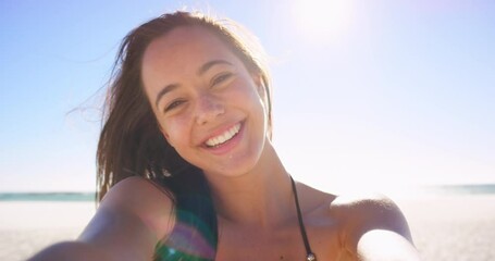 Woman, selfie and blow kiss at beach, flirting and romance emoji for valentines day while live streaming. Female person, portrait and travel influencer on social media, online and vlogger at ocean - Powered by Adobe