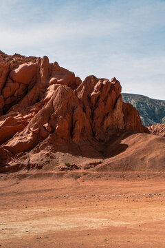 Panoramic view of rock formations against sky,Purmamarca, Jujuy. Argentina.  The desert landscape of red clay and other minerals, in the hill of the 7 colors