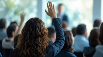 active participation at a conference or seminar, where attendees are raising their hands, likely to ask questions or vote on a discussion point.