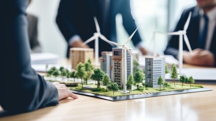 Close-up design of new houses with wind turbines to generate clean electricity. The men of the company solve problems, share their experience in the office. - obrazy, fototapety, plakaty