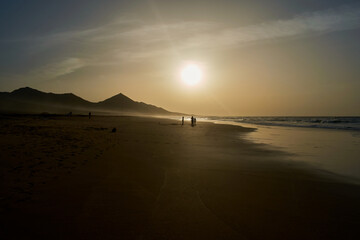 Sunset on Cofete beach in Fuerteventura in Jandia Natural Park with silhouettes and mountains