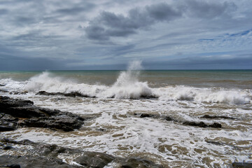 The angry Atlantic Ocean after a few days of the storm with cloudy water