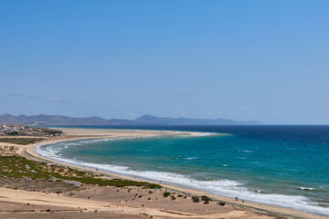 The Atlantic Ocean and Sotavento beach with clear sky and mountains in back