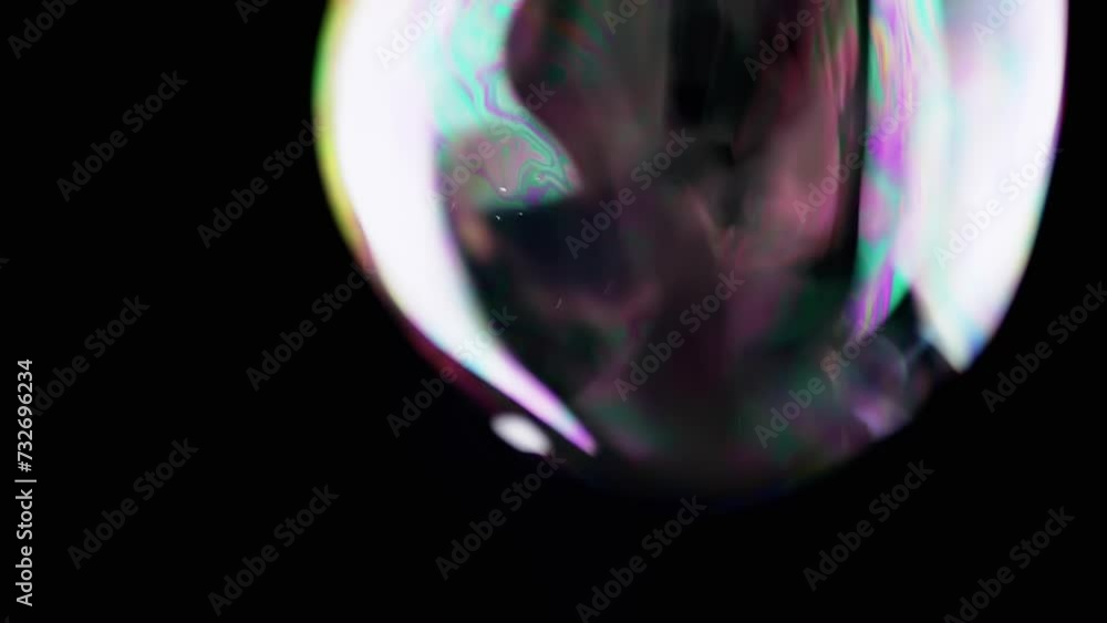 Poster lot of large colorful soap bubbles fly on a black background in empty space. close up. vibrating tra