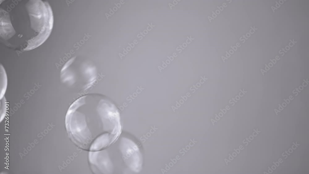 Poster close up, lot soap bubbles float on a gray background in empty space. connection. molecules. chaotic