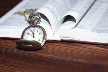 a pocket watch with book background
