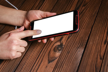 a phone with hands addiction on a wooden background