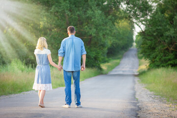 Fototapeta premium A Happy couple walking along the road in the park in nature travel tourist