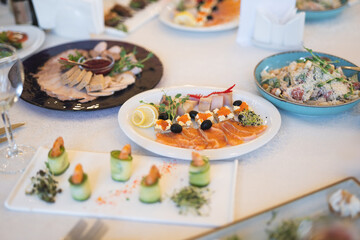 a lot of different food and snacks on the festive table