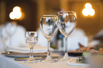 empty goblets and other cutlery are served on the festive table