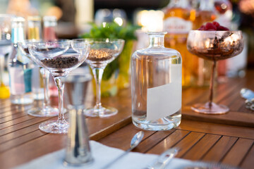 many different ingredients on the bartender's table for making alcoholic cocktails