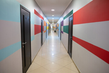interior perspective of a long corridor with colored geometric lines