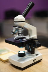 professional microscope in a school laboratory for the study of cells and bacteria