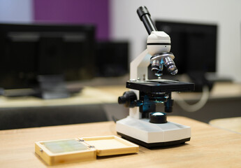 professional microscope in a school laboratory for the study of cells and bacteria