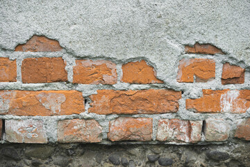 texture of old cracked brick wall and peeling plaster