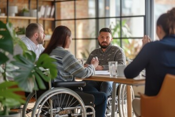 Inclusive business meeting in a modern office, featuring a wheelchair user actively participating and leading the discussion.