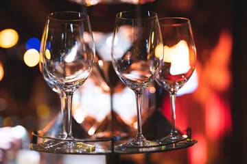 empty clean glass glasses for alcoholic drinks in a restaurant on a bar counter