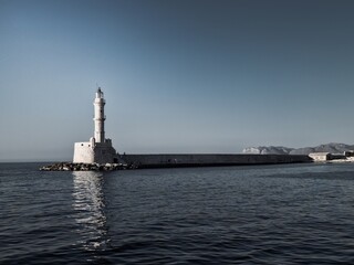 Lighthouse in the city of Chania in Crete, a beautiful bay overlooking the Mediterranean Sea. Beautiful sunrise and a spectacular lighthouse