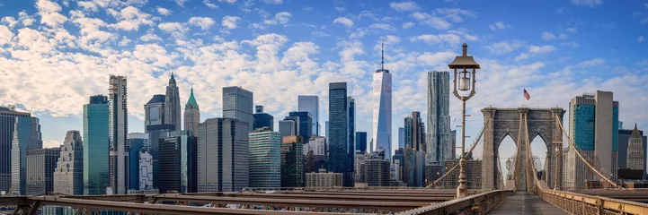 Foto op Plexiglas New York City Manhattan Skyline over the Brooklyn Bridge, skyscrapers, the landmark Gothic-Revival massive granite towers, and wooden footpath over the East River in New York © Naya Na