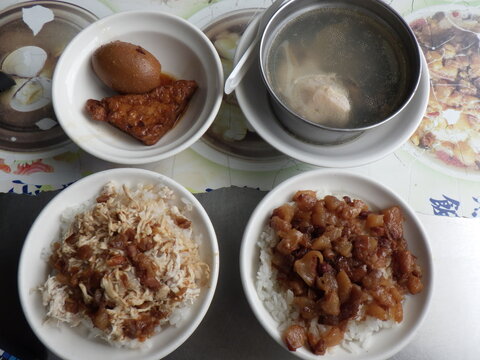 KAOHSIUNG, TAIWAN - January 1, 2024 :Chicken rice, pork rice, soup, and side dishes that I ate in Kaohsiung, Taiwan