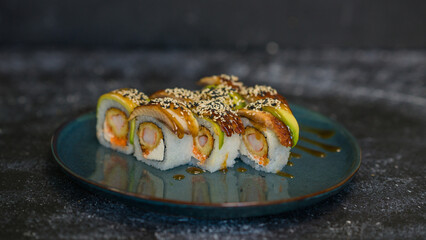 Sushi rolls are served on a plate. soy sauce. Delicious seafood food.