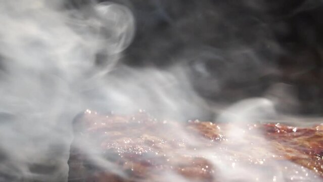 Close up of delicious beef steak on flaming grill. Barbecue grill. Cooking Health low cholesterol Lean Meat.