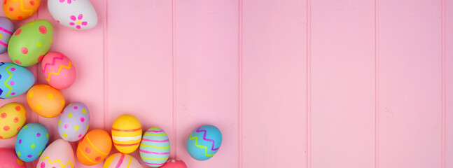 Colorful Easter Egg double border over a soft pink wood banner background. Copy space.