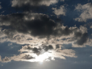 Sunbeams break through dramatic sky with dark clouds