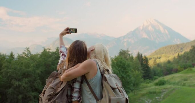 Women, friends and selfie for mountain explore in Italy for backpacking adventure, vacation or social media. Female people, behind and countryside hill for online post or tourism, travel or holiday