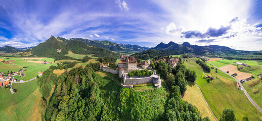 Switzerland travel and landmarks. scenic medieval village and castle Gruyere. canton Fribourg. Aerial panoramic drone view - 732726624