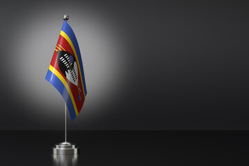 Fototapeta premium Small National Flag of the Kingdom of Eswatini on a Black Background. 3d Rendering
