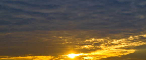 Naklejka na ściany i meble sky with cirrus clouds and bright sunrise. Wide photo.