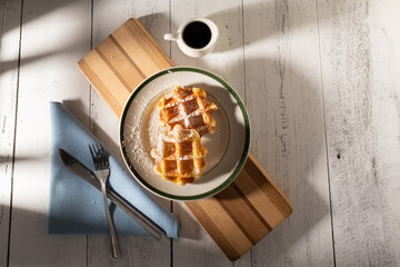 Belgium Waffles with syrup and utensils