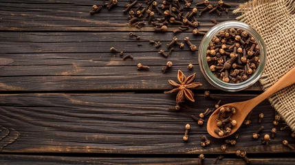  a jar of cloves and spices on a wooden table © Vahagn