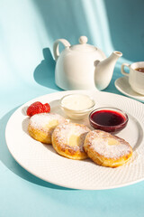 Delicious Breakfast of Cottage Cheese Pancakes with Fresh Strawberries and Sour Cream