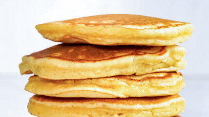 Pancakes fluffy stack on white plate, delicious food. Homemade freshly baked pancakes for American...