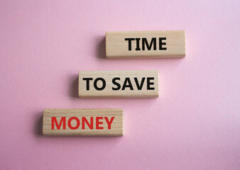 Time to save money symbol. Wooden blocks with words Time to save money. Beautiful pink background. Business and Time to save money concept. Copy space.