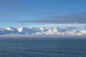 Fototapeta na wymiar Atlantic ocean and snowy mountains, North Iceland