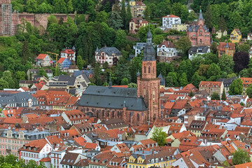 Church of the Holy Spirit in Heidelberg Old Town, Germany. High angle view from a hill at the opposite bank of Neckar river. The church was constructed between 1398 and 1515.