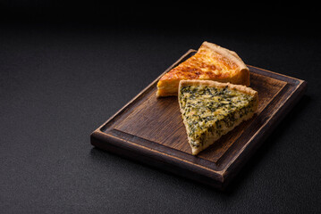 Delicious crispy quiche cut into slices with cheese, broccoli, tomatoes