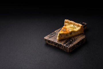 Delicious crispy quiche cut into slices with cheese, broccoli, tomatoes