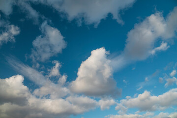 Blue sky with cumulus clouds.