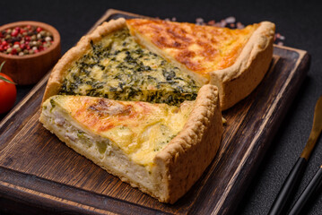 Delicious crispy quiche cut into slices with cheese, broccoli, tomatoes