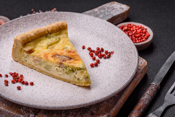 Delicious crispy quiche cut into slices with cheese, broccoli, tomatoes